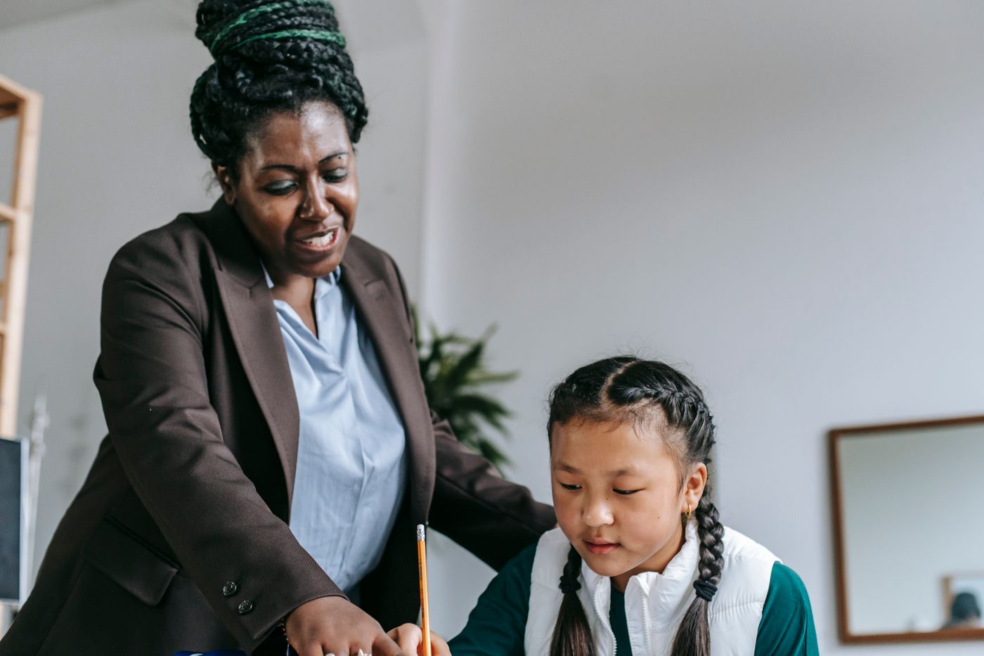 A teacher supporting a learner with classroom work
